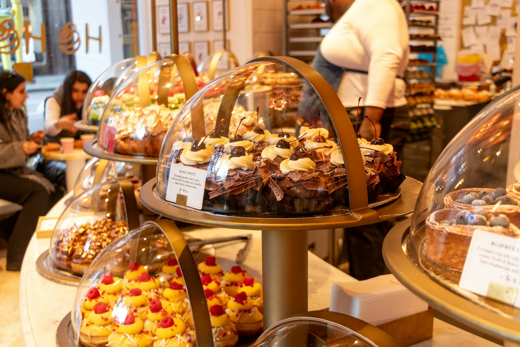 Customers and staff inside a London bakery
