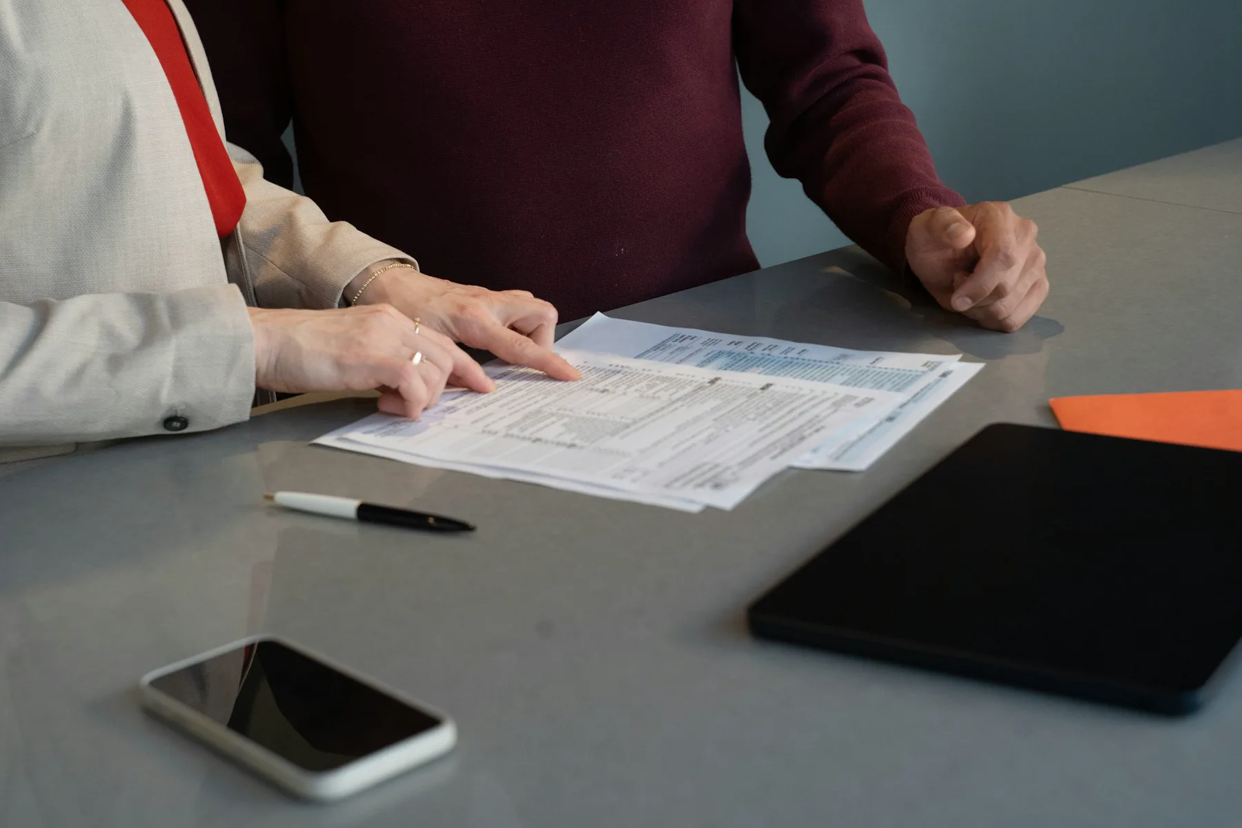 Two people reviewing paperwork together