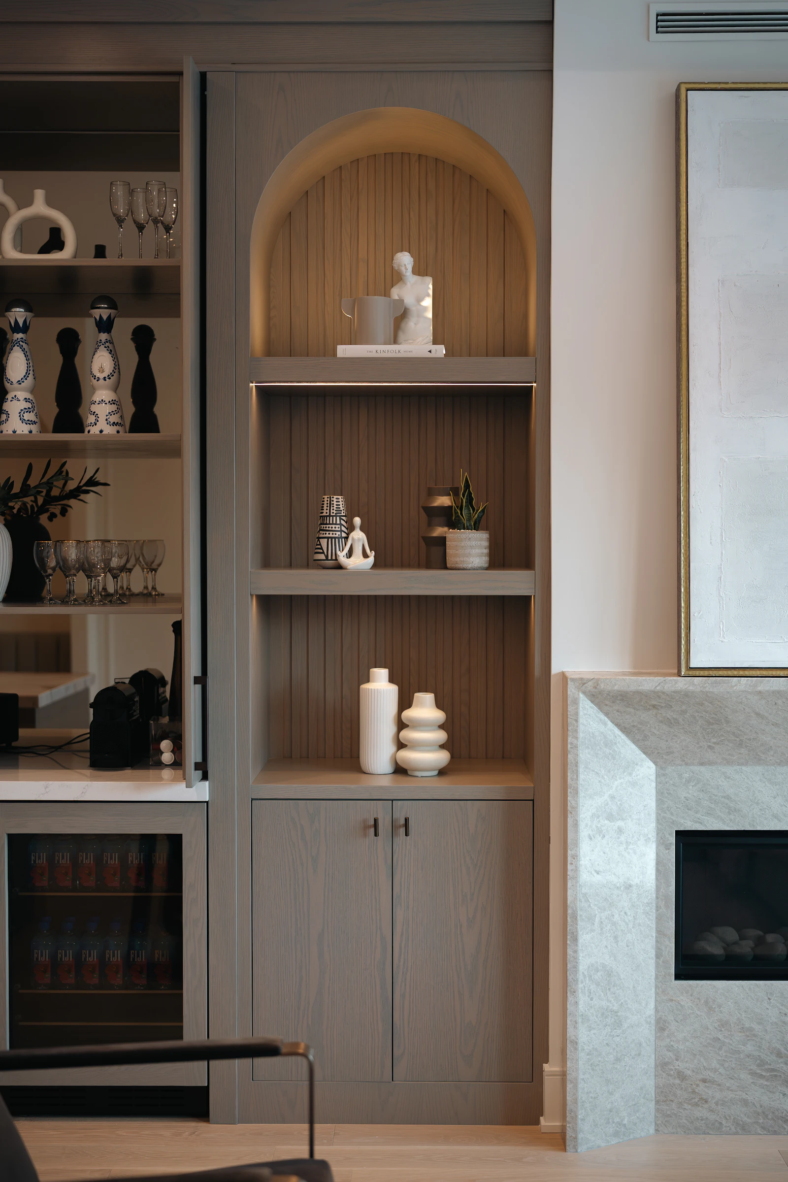 Fitted shelves arranged around books and objects