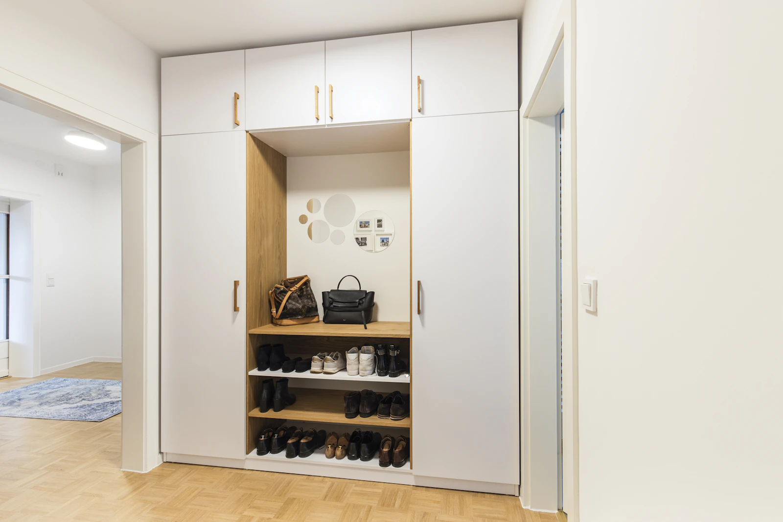 Built-in hallway storage with a bench and shoe shelves