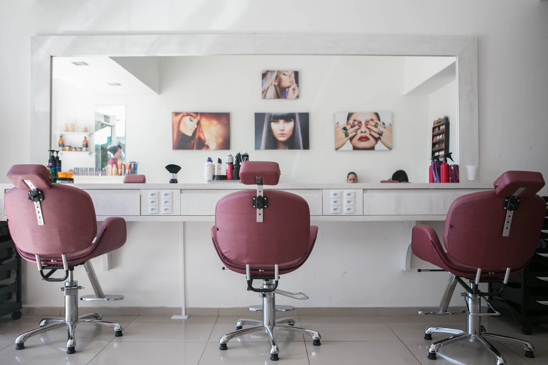 A bright salon with mirrors and styling chairs