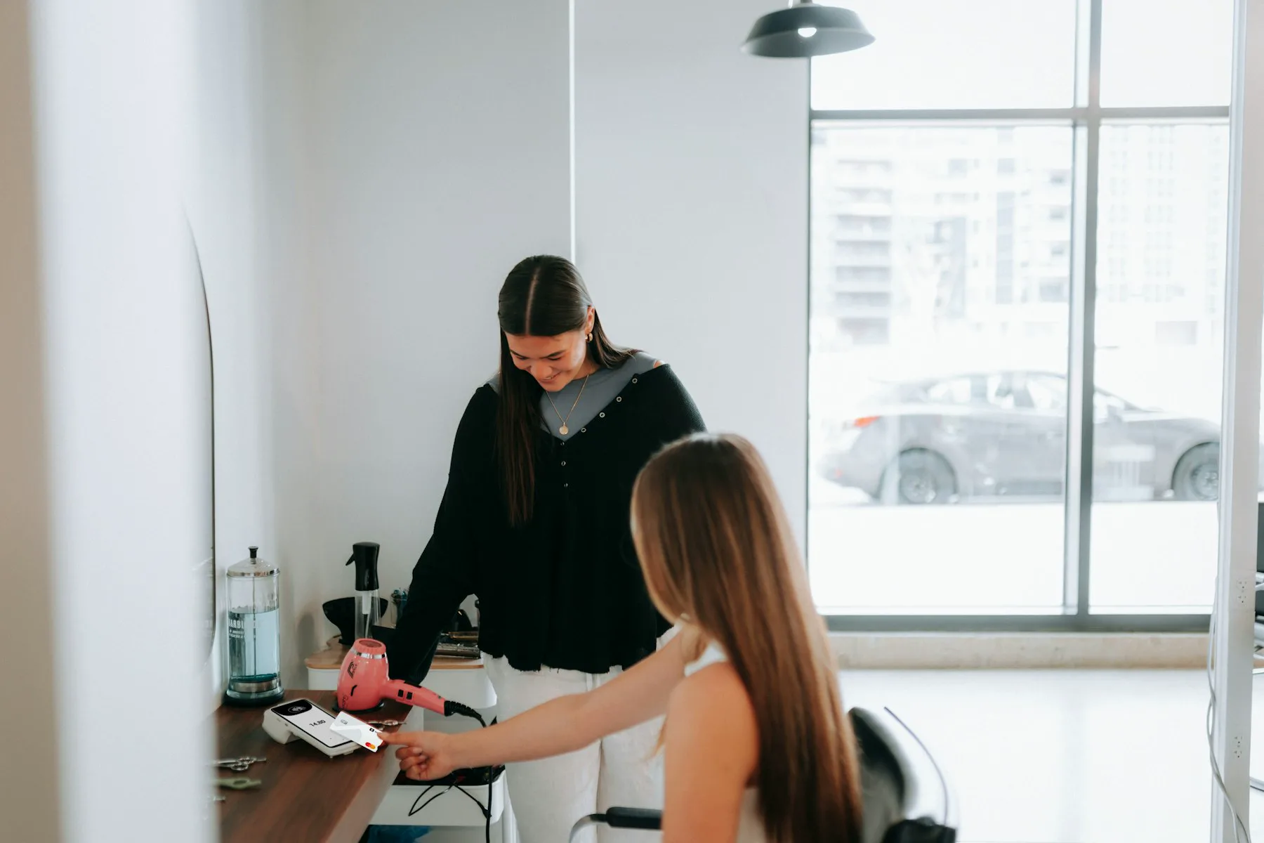 A stylist consulting with a seated client