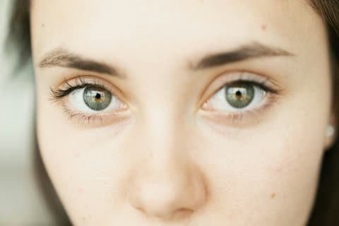 An extreme close-up of a person’s eyes and upper face