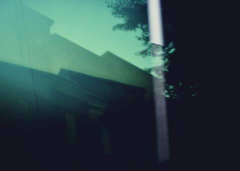 A pale reflection crosses dark blue architectural glass