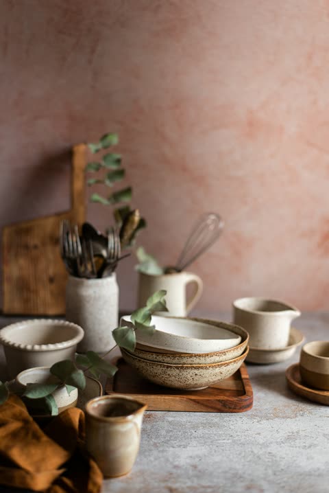 Handmade bowls and kitchen tools arranged on a table